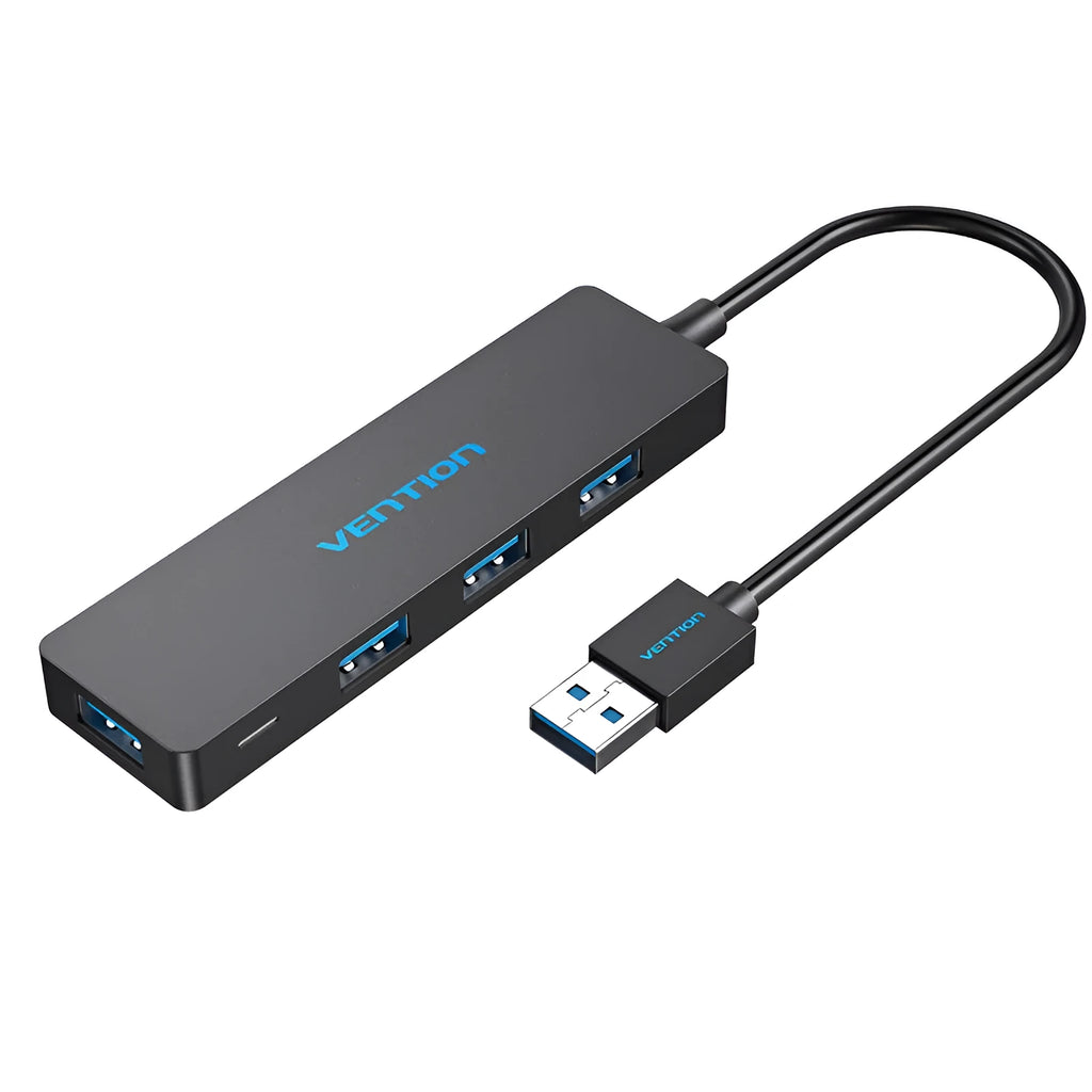 Black USB 3.0 four-port hub with a short cable and nickel-plated connectors on a desk.