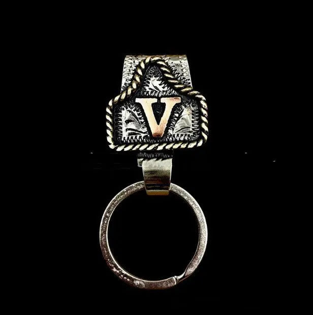 Handmade metal cow tag belt keychain showing the belt loop and one of 26 available alphabet colour options.