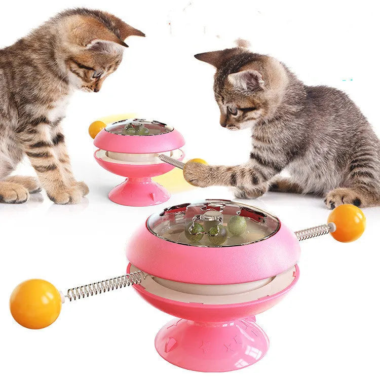Rotating turntable cat toy with transparent top showing catnip balls, in lake blue colour with a large white suction cup base.