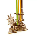 Ukrainian wooden desk pen holder with a steering wheel crank and rotating mechanism.