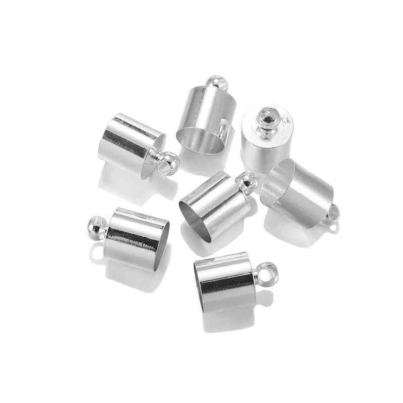 Assortment of electroplated copper weight caps in gold, silver, and bronze finishes for jewellery making.
