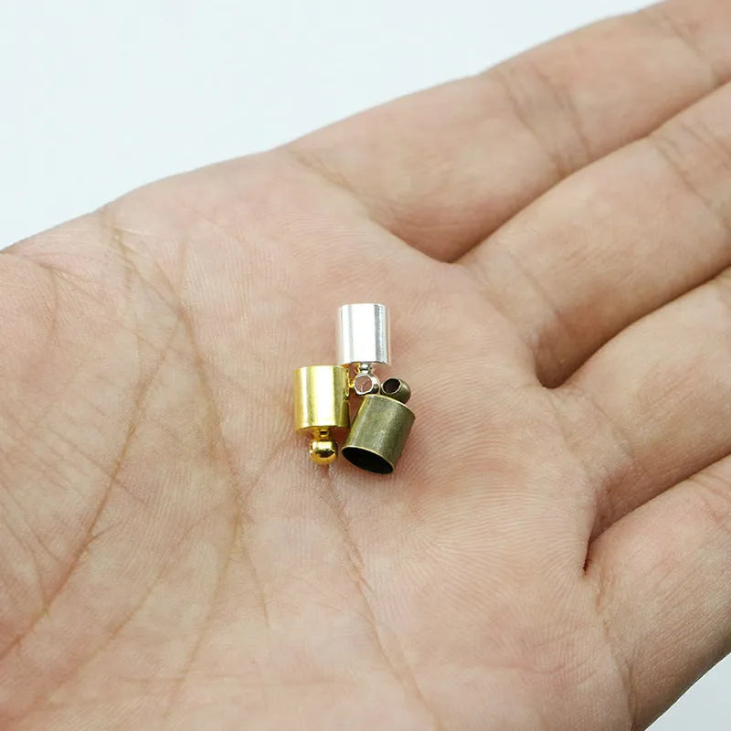 Assortment of electroplated copper weight caps in gold, silver, and bronze finishes for jewellery making.