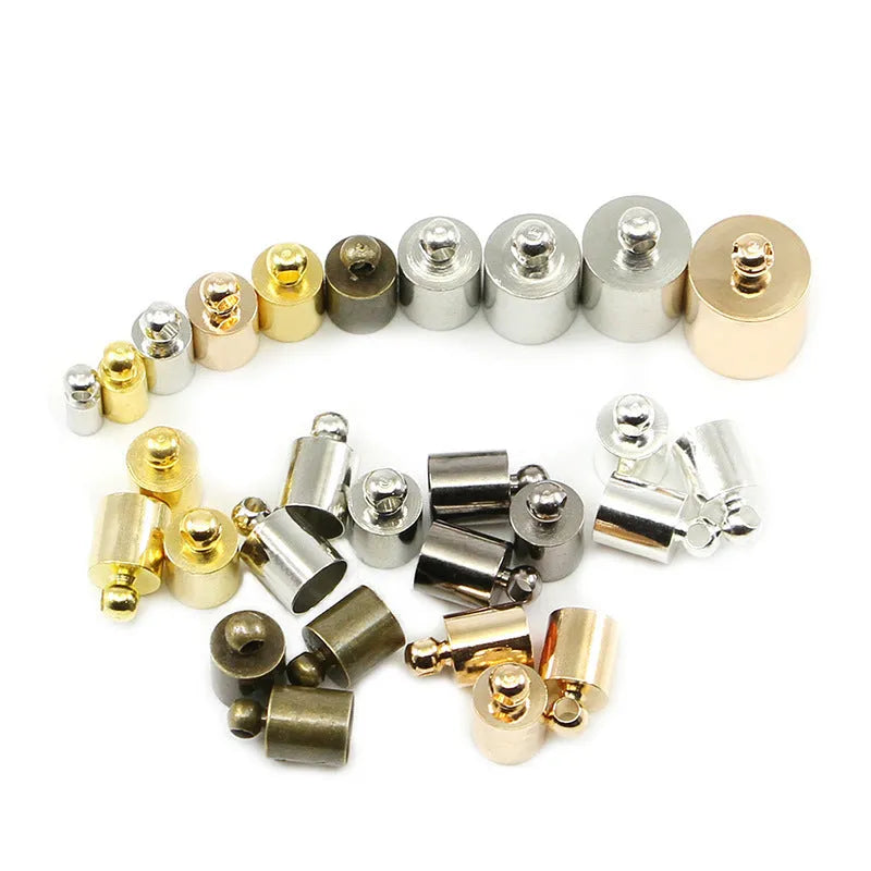 Assortment of electroplated copper weight caps in gold, silver, and bronze finishes for jewellery making.