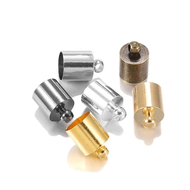 Assortment of electroplated copper weight caps in gold, silver, and bronze finishes for jewellery making.