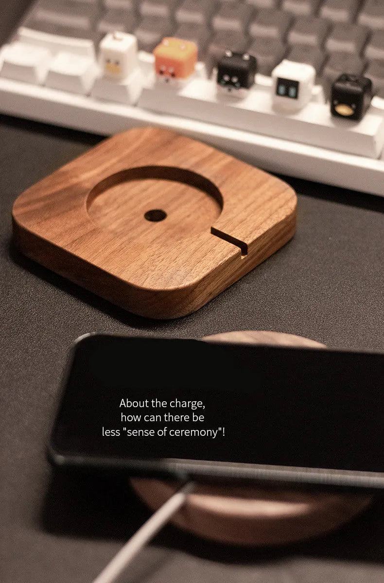 Walnut wood magnetic wireless charging base with phone attached on desktop