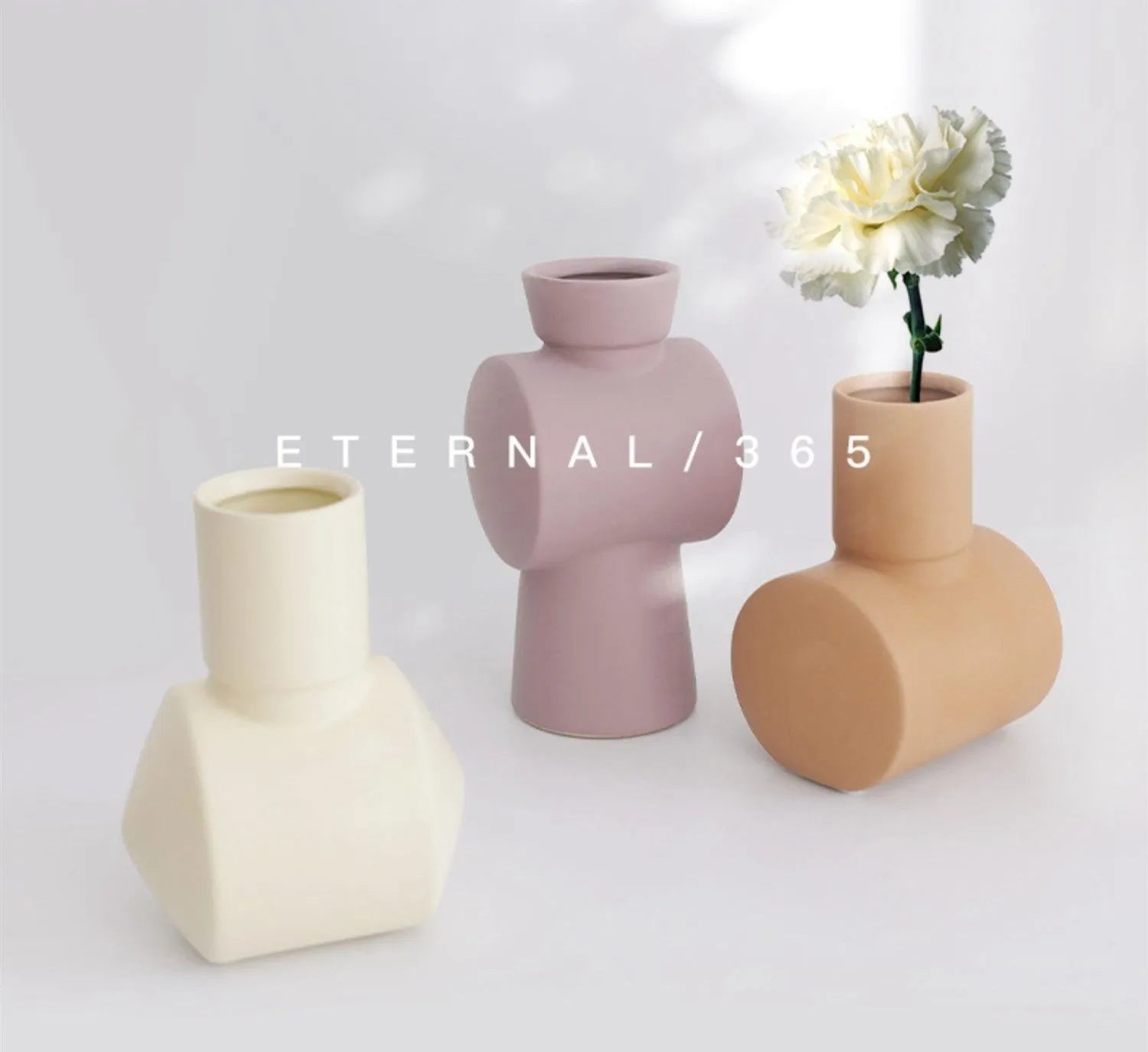 Nordic style hammered ceramic vase in Morandi beige on a wooden shelf.