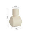 Nordic style hammered ceramic vase in Morandi beige on a wooden shelf.