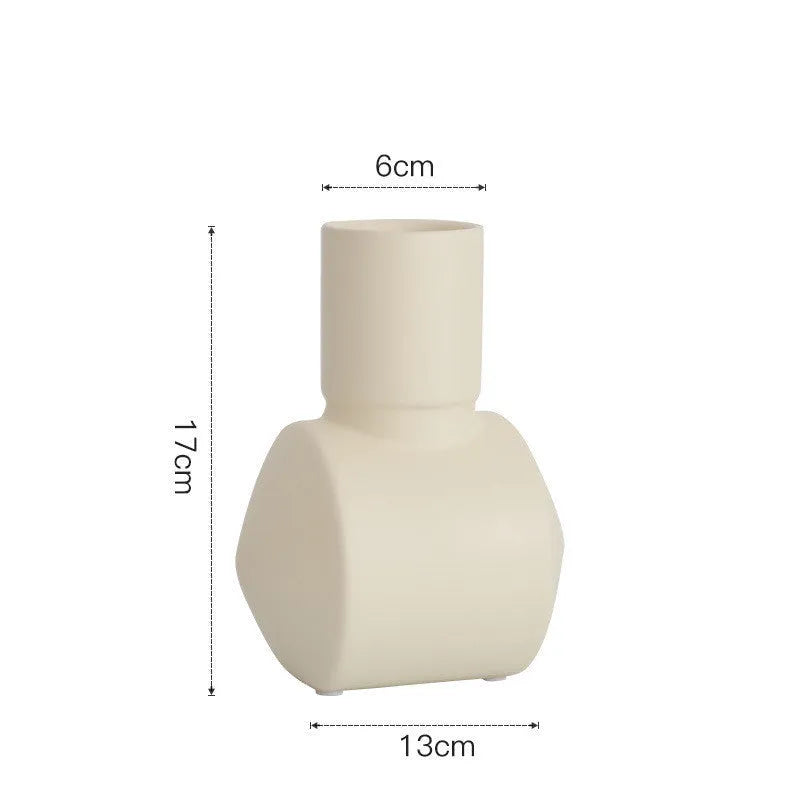 Nordic style hammered ceramic vase in Morandi beige on a wooden shelf.