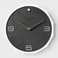 12-inch round minimalist wall clock with Geralt-style perforated design in four colour options.