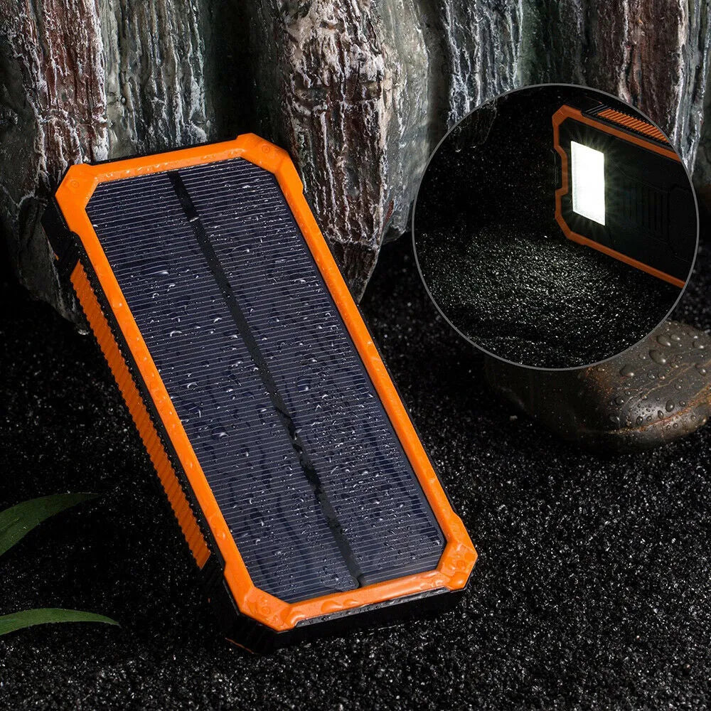 Solar power bank in orange colour showing solar panel and multiple USB ports