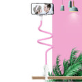 Blue mobile phone holder with flexible memory alloy hose positioned on a bedside table, holding a smartphone.