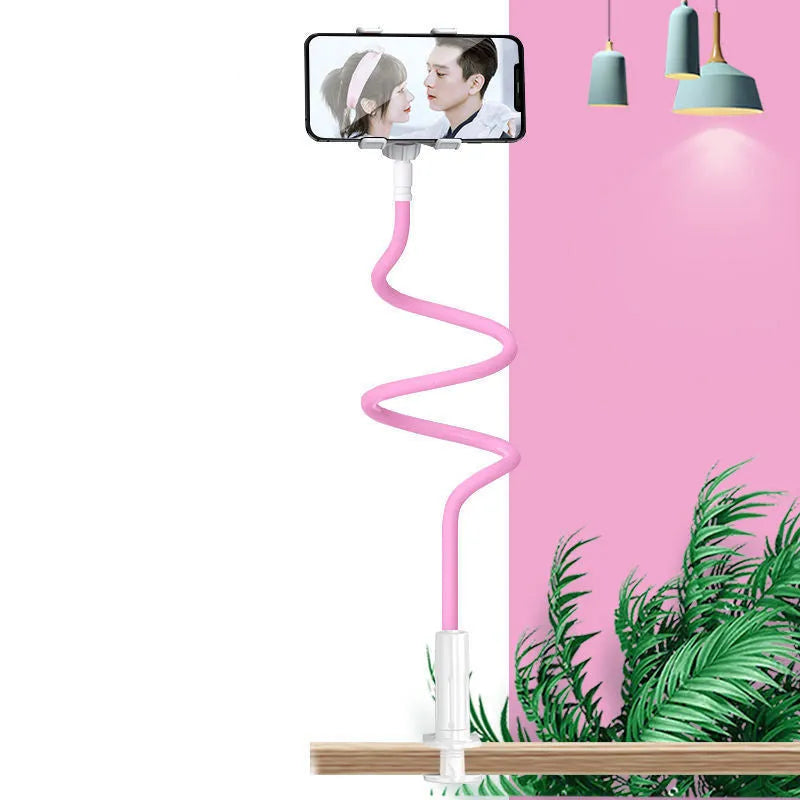 Blue mobile phone holder with flexible memory alloy hose positioned on a bedside table, holding a smartphone.
