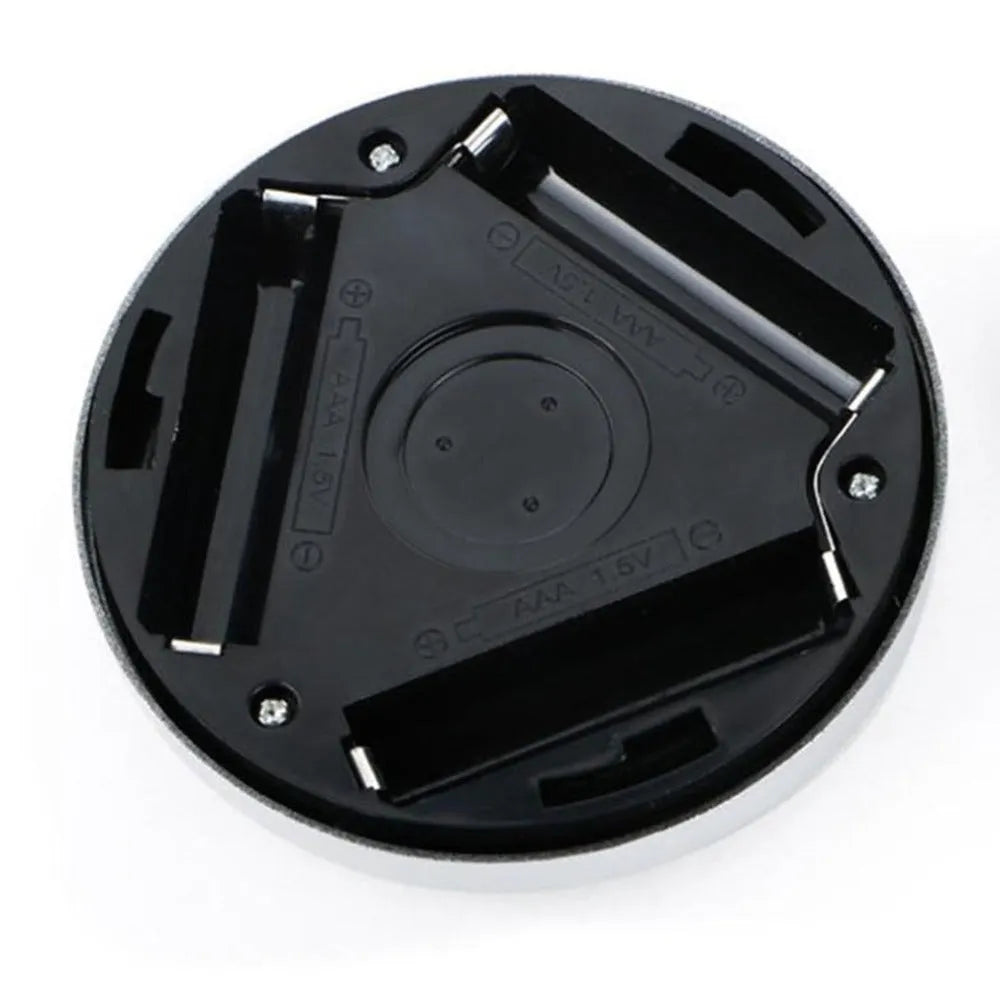 Silver circular motion sensor night light with 80mm diameter on table