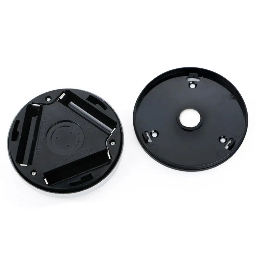 Silver circular motion sensor night light with 80mm diameter on table