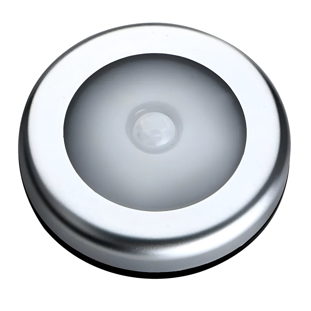 Silver circular motion sensor night light with 80mm diameter on table