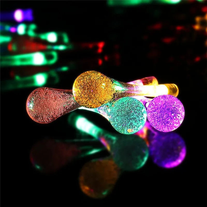 Solar LED outdoor string lights with water drop shaped pendants on a 6.5 metre cable for garden decoration