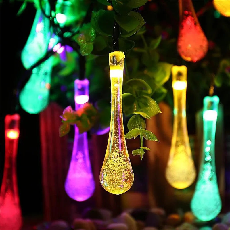 Solar LED outdoor string lights with water drop shaped pendants on a 6.5 metre cable for garden decoration
