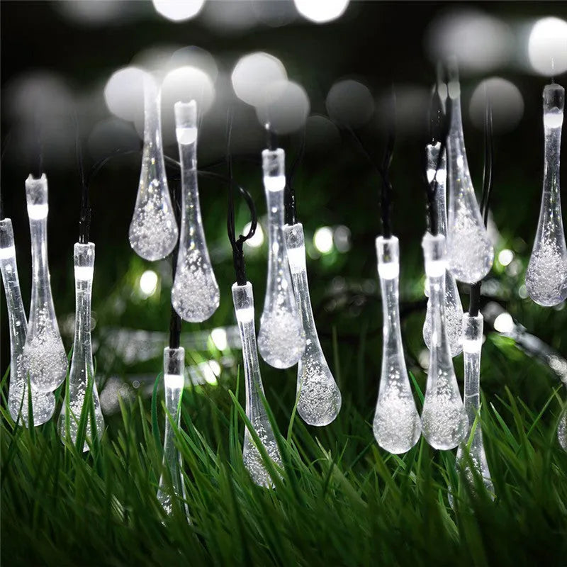 Solar LED outdoor string lights with water drop shaped pendants on a 6.5 metre cable for garden decoration