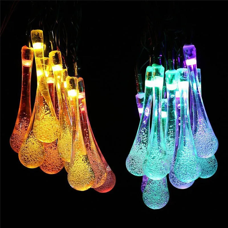Solar LED outdoor string lights with water drop shaped pendants on a 6.5 metre cable for garden decoration