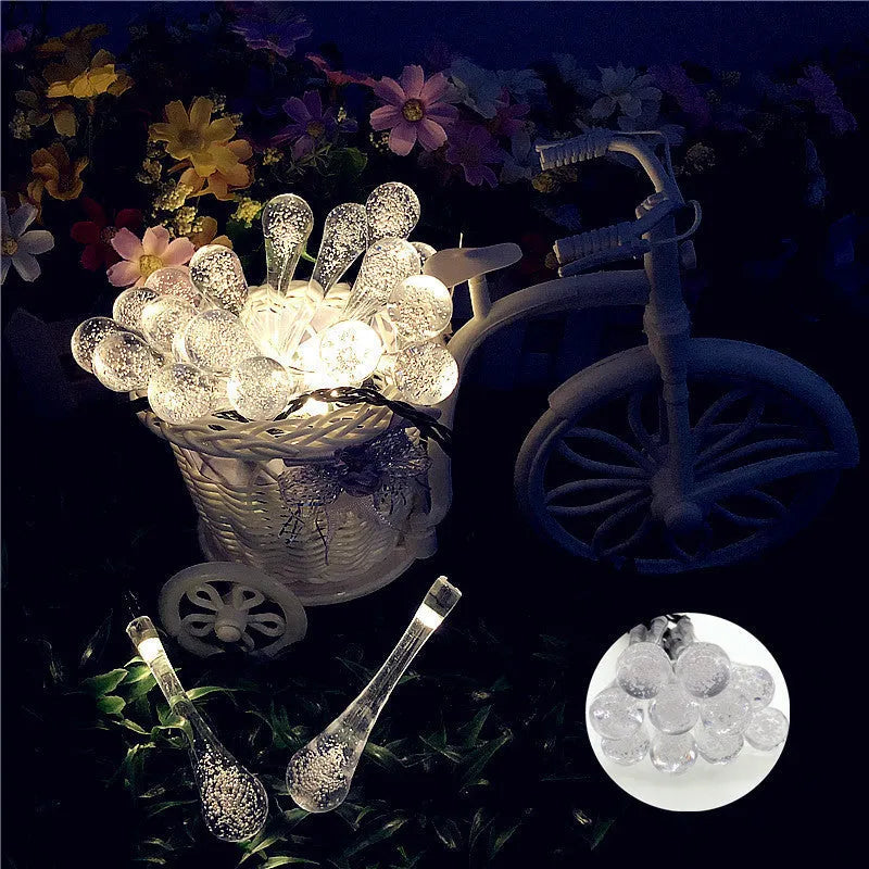 Solar LED outdoor string lights with water drop shaped pendants on a 6.5 metre cable for garden decoration
