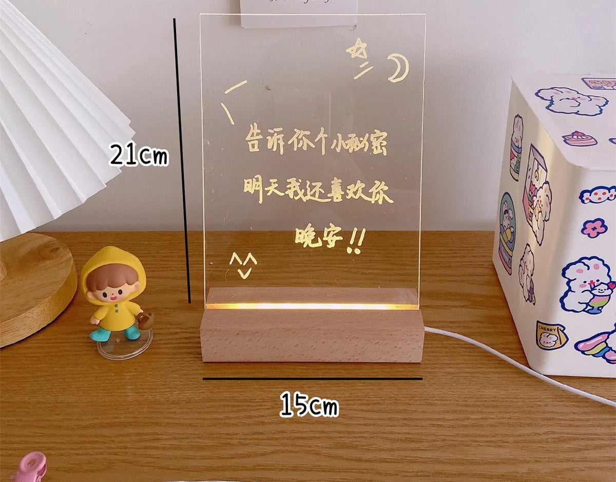 A white LED bedside lamp on a wooden table, shown next to a message board variant with an erasable pen.