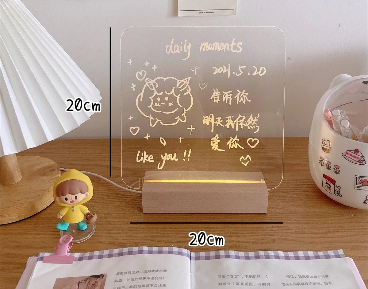 A white LED bedside lamp on a wooden table, shown next to a message board variant with an erasable pen.