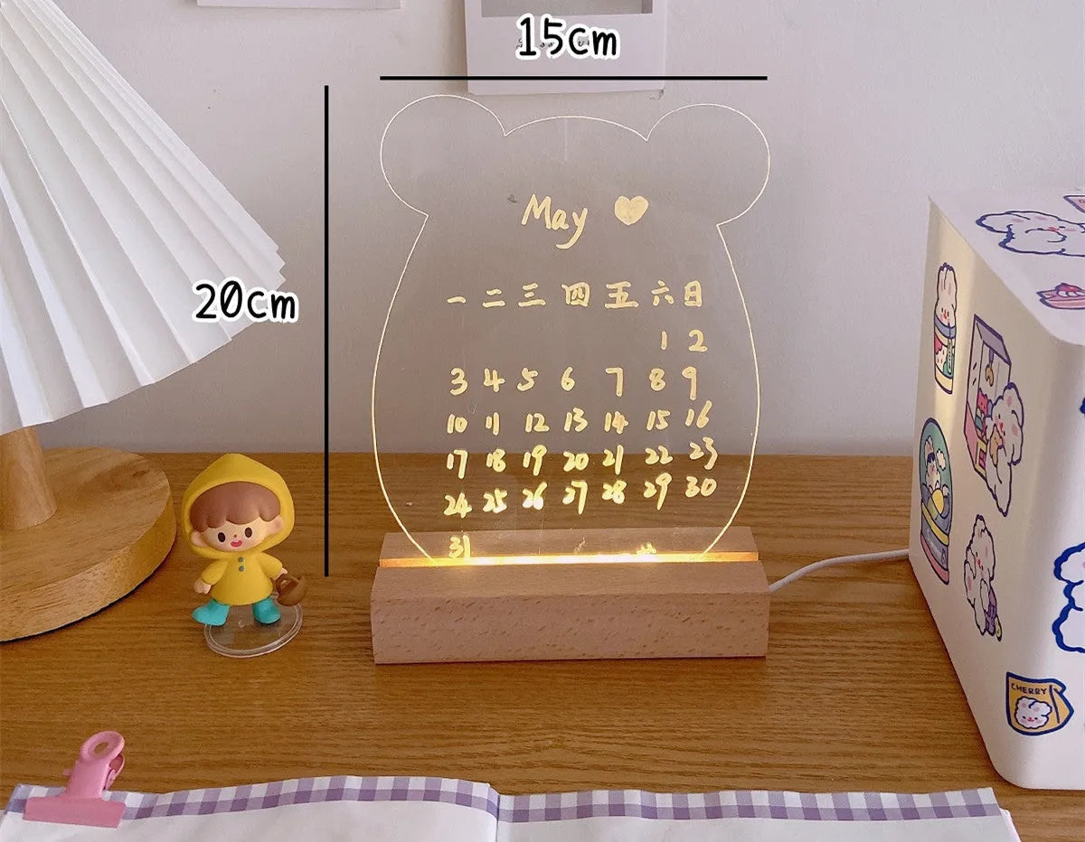 A white LED bedside lamp on a wooden table, shown next to a message board variant with an erasable pen.