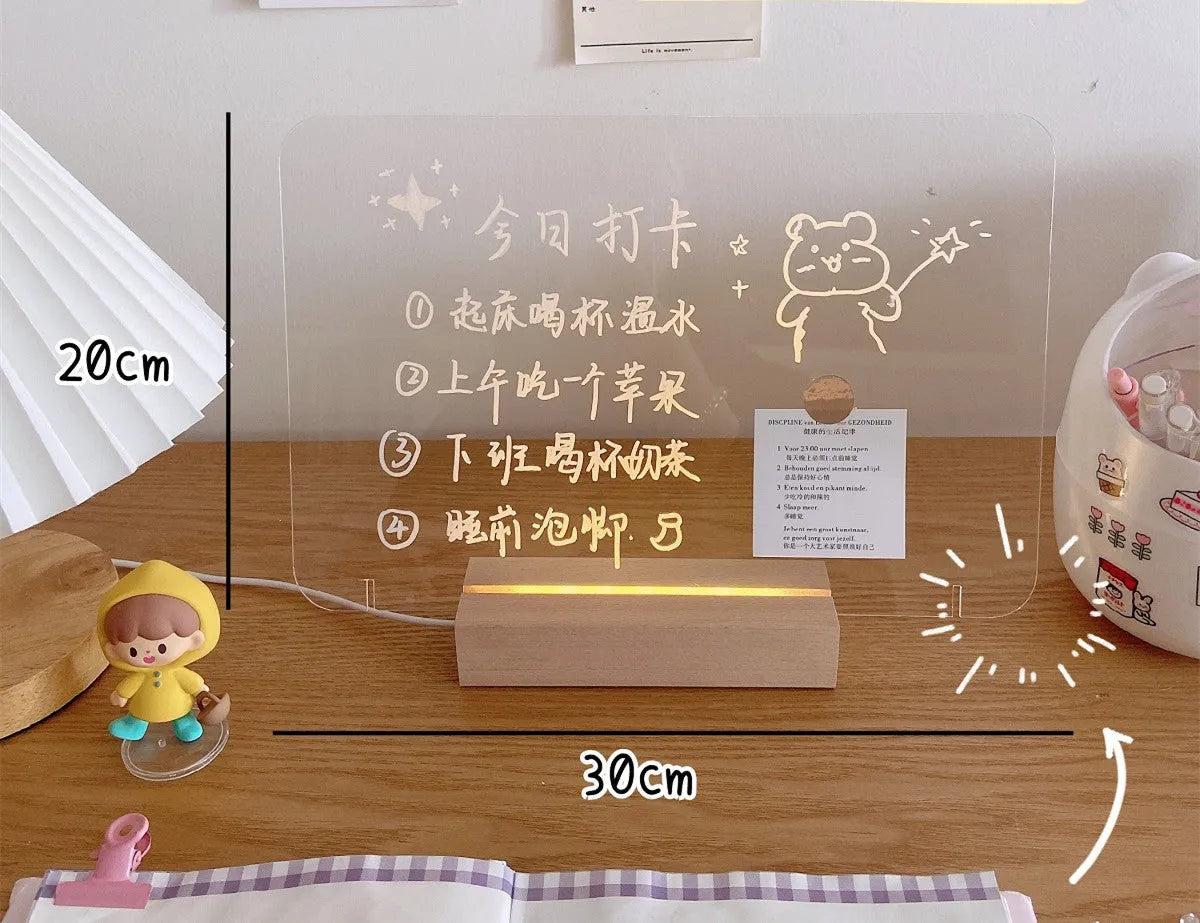A white LED bedside lamp on a wooden table, shown next to a message board variant with an erasable pen.