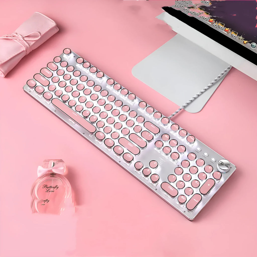 Wired silver mechanical keyboard with pink round keycaps and green switches next to matching mouse.