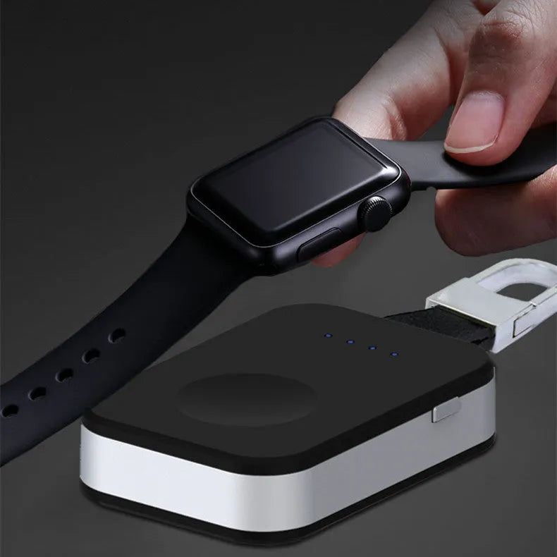 Black keychain-sized wireless power bank for Apple Watch showing front view and size relative to a keyring.