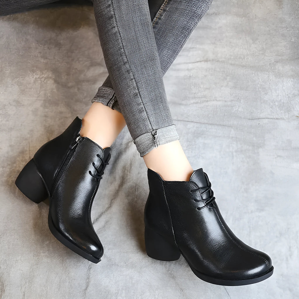 Women's black leather Martin boots with a thick 3-5cm heel and round toe on a rubber sole.