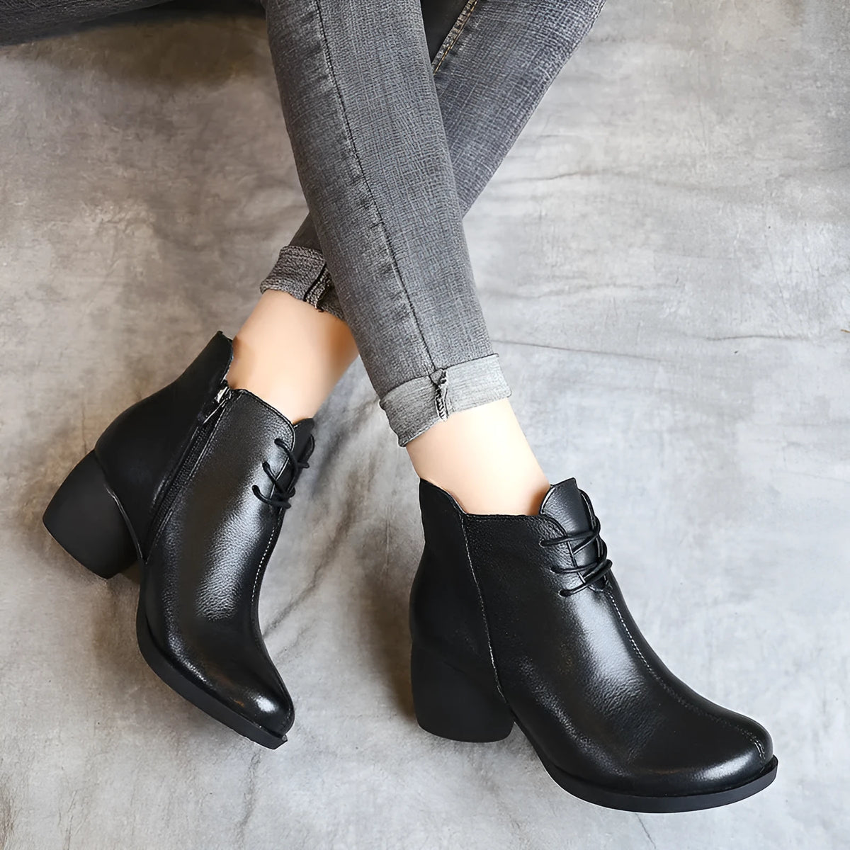 Women's black leather Martin boots with a thick 3-5cm heel and round toe on a rubber sole.