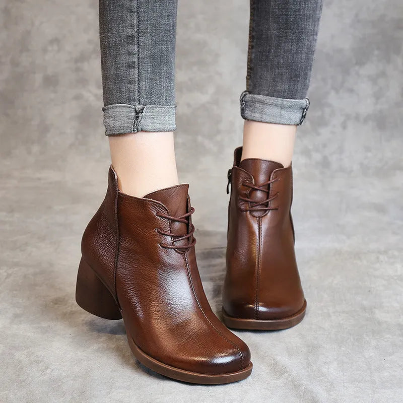 Women's black leather Martin boots with a thick 3-5cm heel and round toe on a rubber sole.