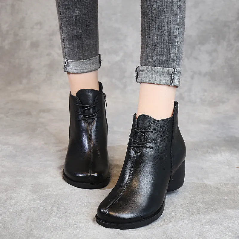 Women's black leather Martin boots with a thick 3-5cm heel and round toe on a rubber sole.