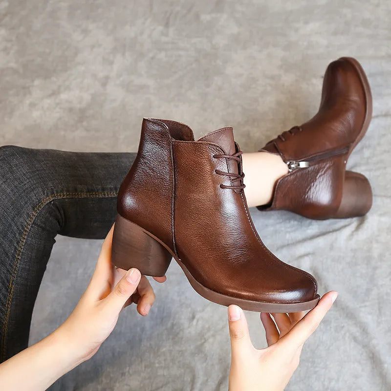 Women's black leather Martin boots with a thick 3-5cm heel and round toe on a rubber sole.