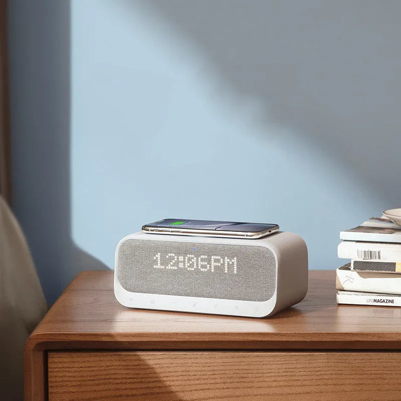 White Anker Soundcore Bluetooth speaker with wireless charging top and digital clock display