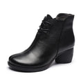 Women's black leather Martin boots with a thick 3-5cm heel and round toe on a rubber sole.