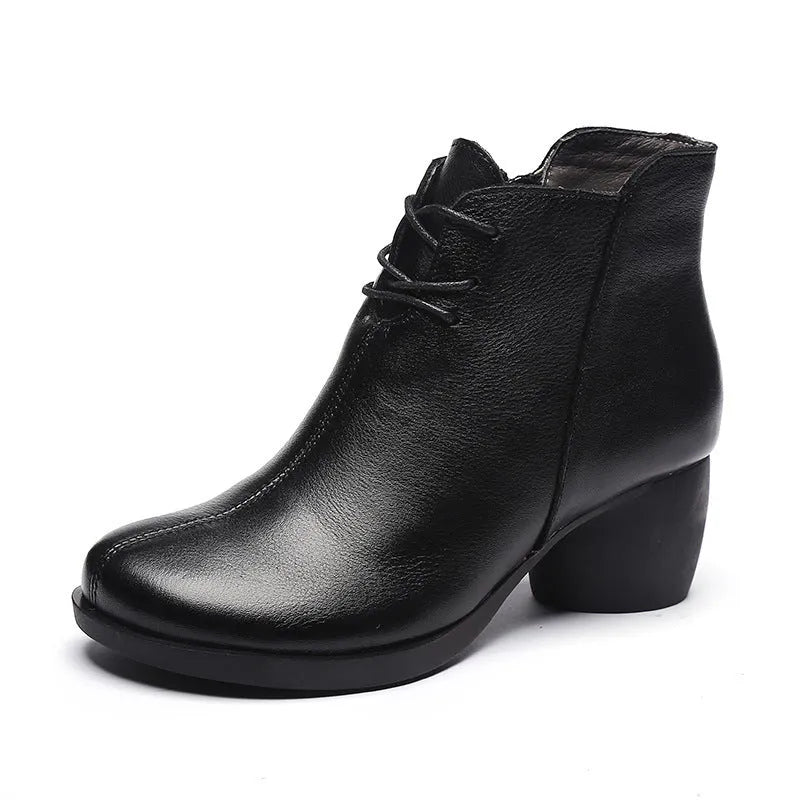 Women's black leather Martin boots with a thick 3-5cm heel and round toe on a rubber sole.