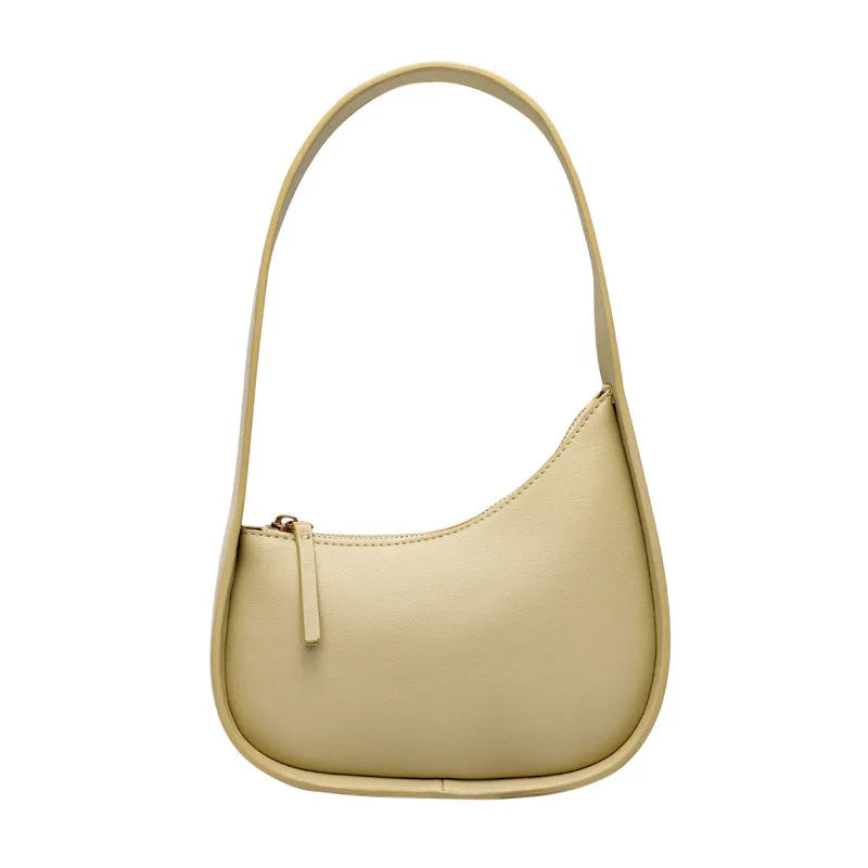 Small half moon leather ladies shoulder bag with wide strap in caramel colour