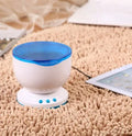 Blue stationary ocean projection lamp with DLP technology on a surface.
