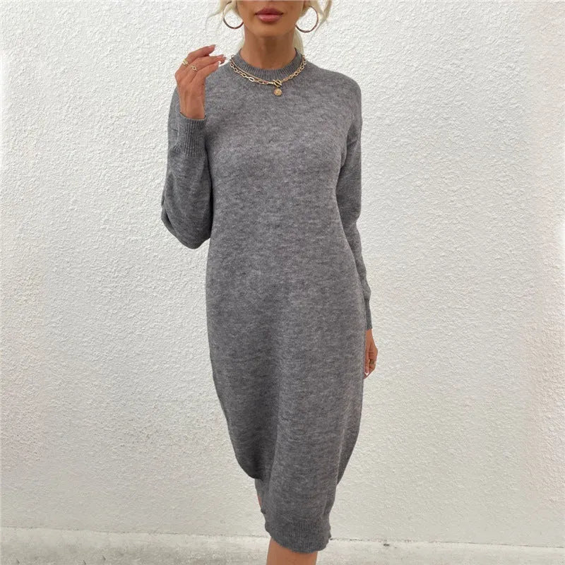 Grey women's crew neck acrylic pullover sweater with long sleeves on a hanger.