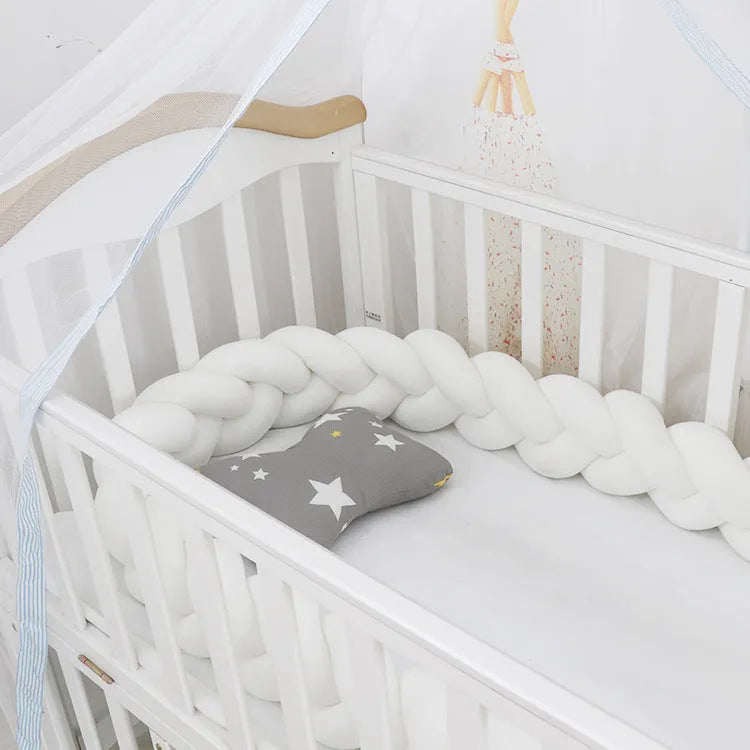 Braided knot design baby crib bumper in spandex velvet, shown in a light grey colour.
