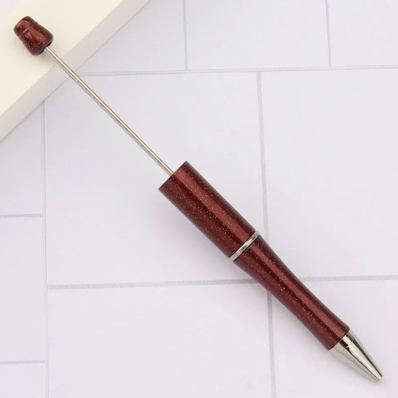 Ballpoint pen with colourful spinning plastic beads on barrel, shown in a gradient purple finish.