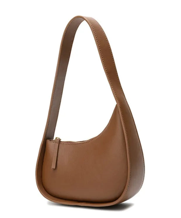 Small half moon leather ladies shoulder bag with wide strap in caramel colour