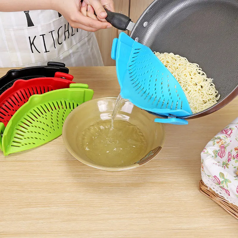 Silicone clip-on funnel strainer attached to kitchen pot for draining liquids