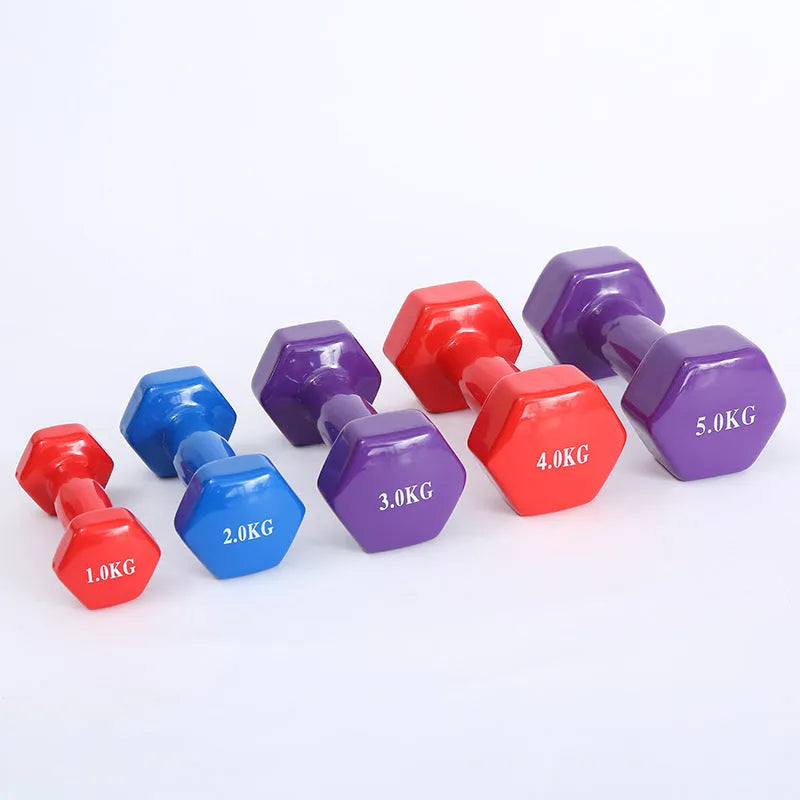Set of bright green and purple plastic dumbbells on a wooden floor.