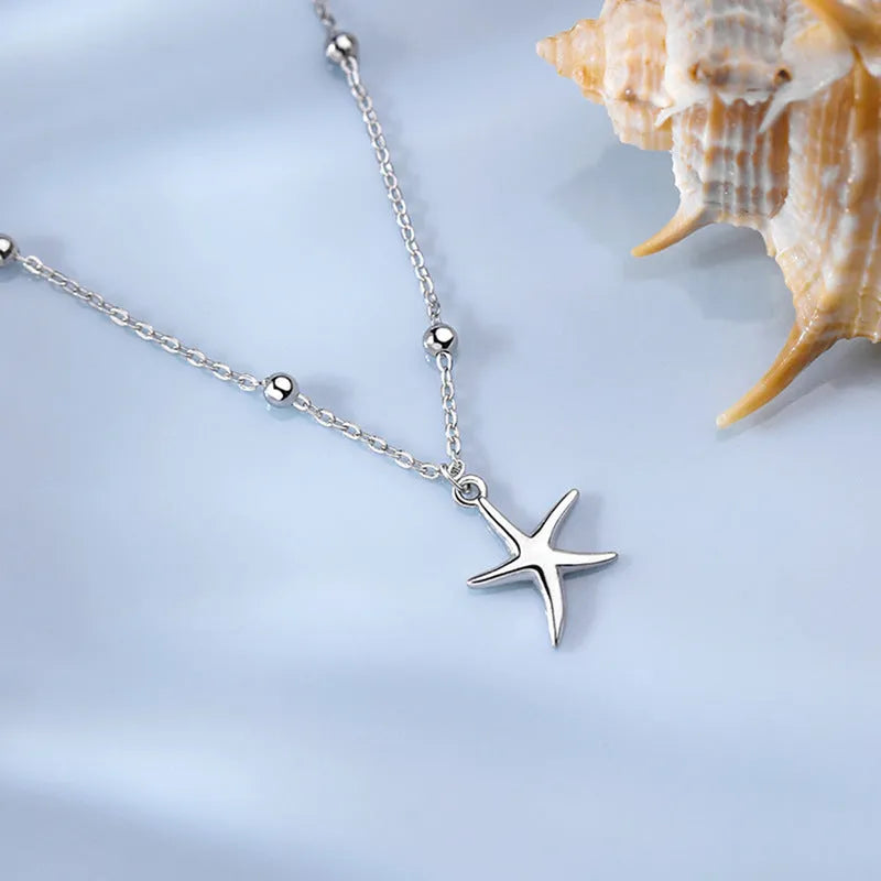 Women's sterling silver anklet with starfish charm and round beads on adjustable chain