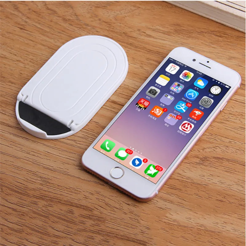 Plastic lazy bracket mobile phone stand in six colour options: black, blue, grey, pink, white, and yellow.