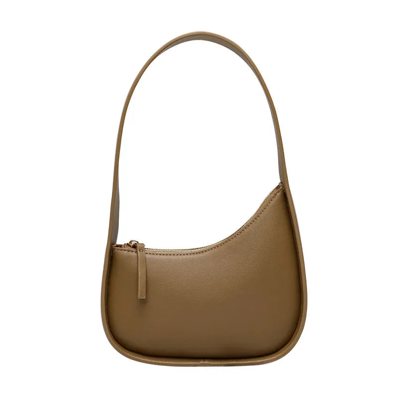 Small half moon leather ladies shoulder bag with wide strap in caramel colour