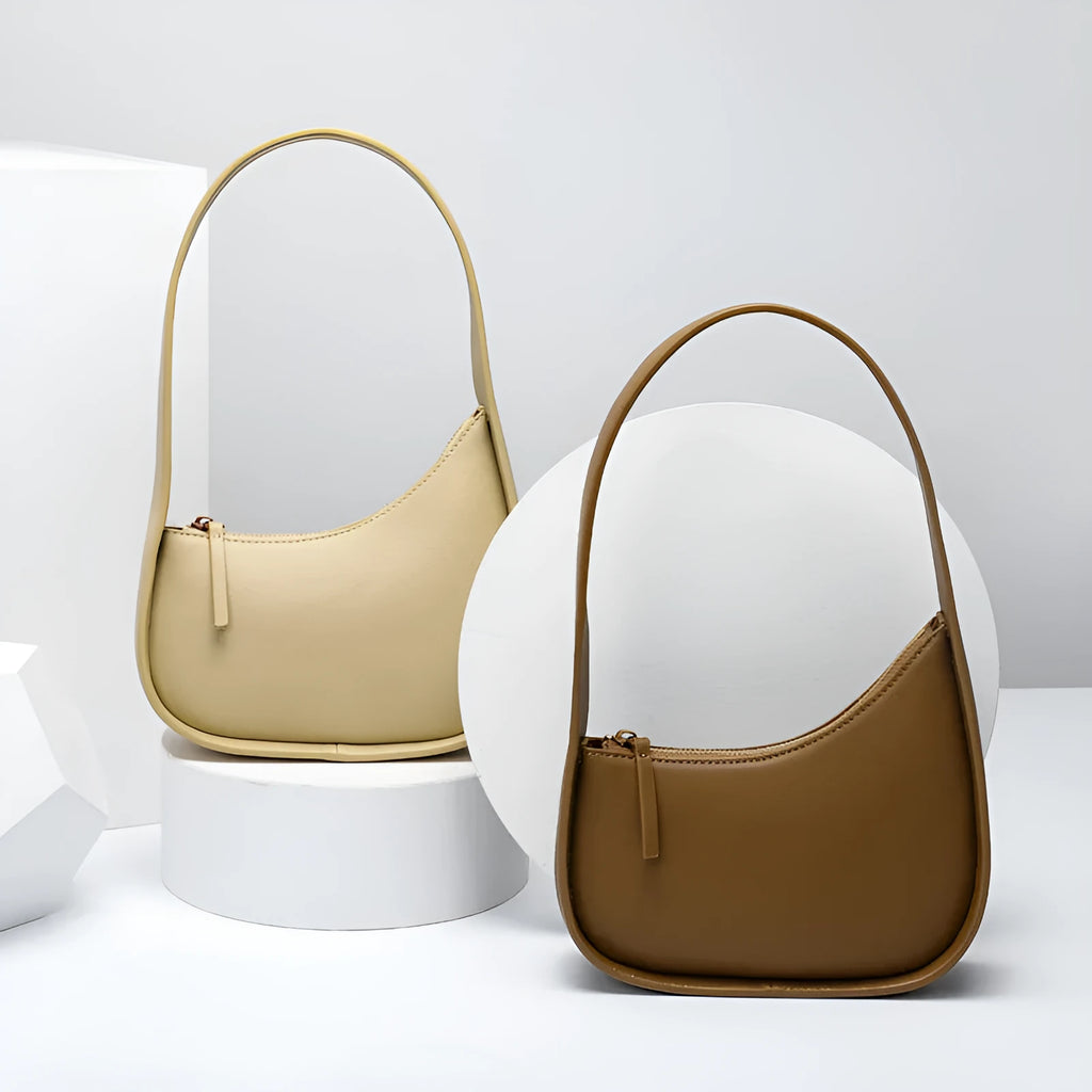 Small half moon leather ladies shoulder bag with wide strap in caramel colour